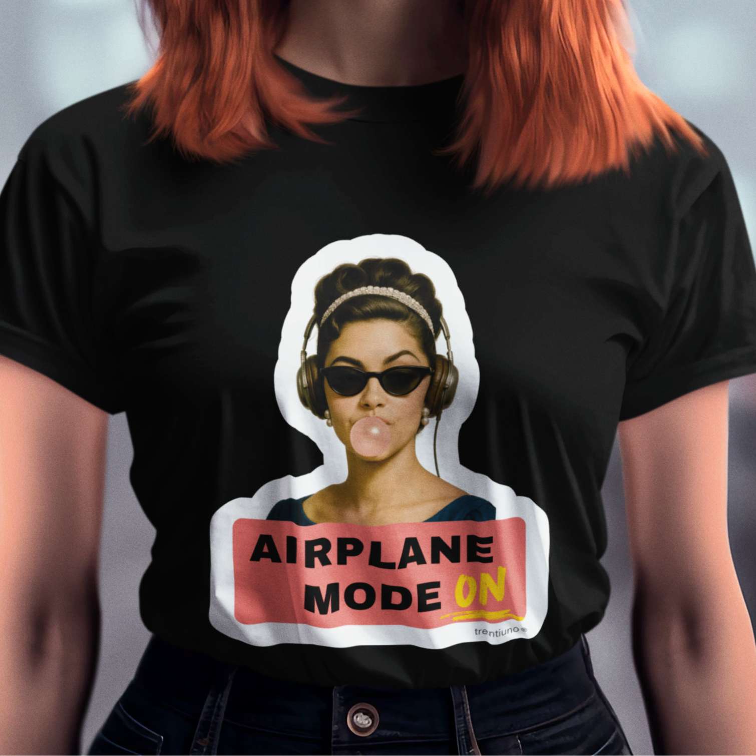 Woman wearing a black t-shirt with an 'Airplane Mode On' graphic design.