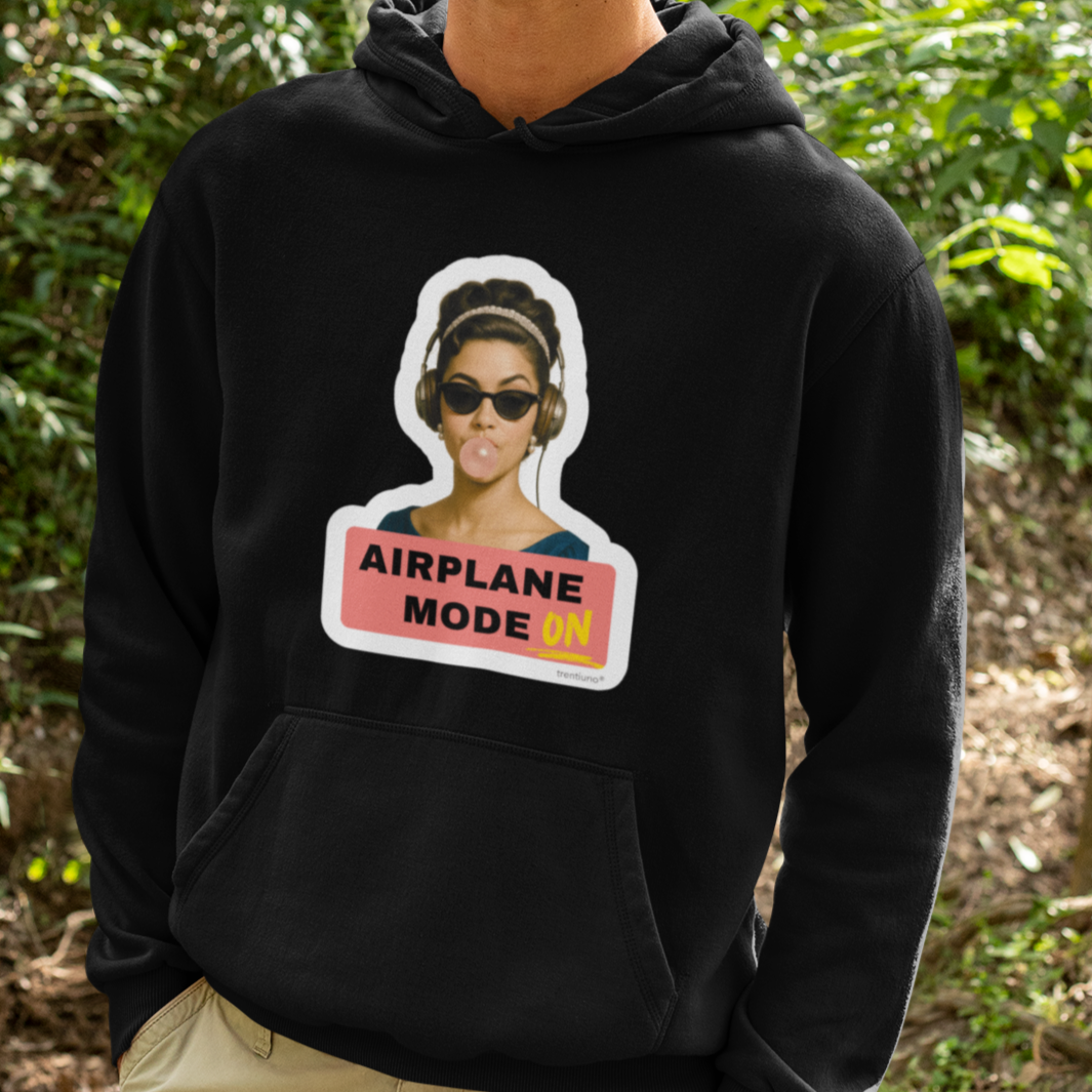 Person wearing a black hoodie with a graphic design outdoors