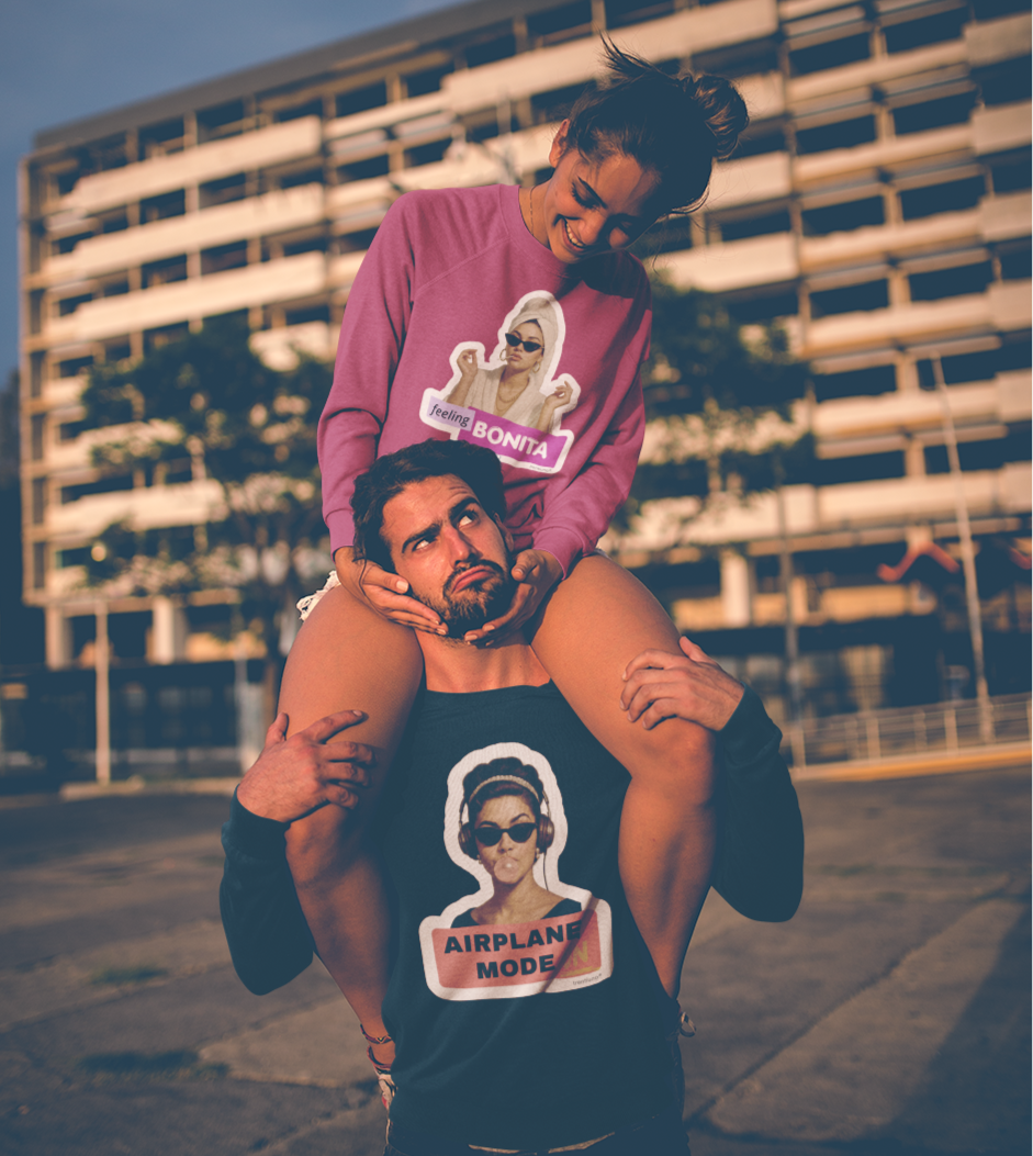 Two people wearing t-shirts with graphic designs in an urban setting