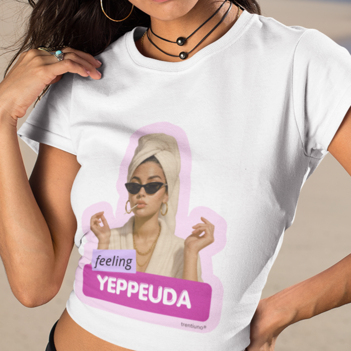 Woman wearing a white t-shirt with a graphic design on a beach
