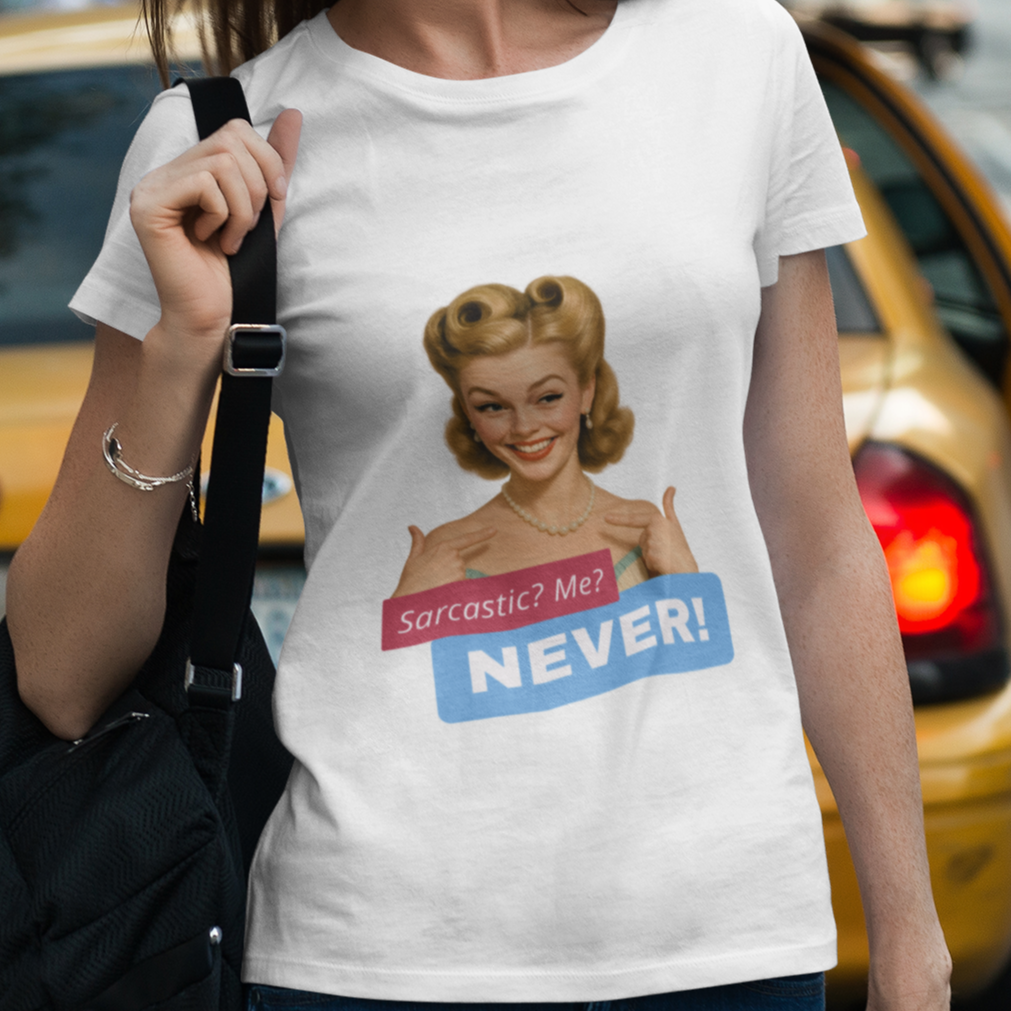 Woman wearing a t-shirt with a graphic design of a woman's bust and text, walking on a city street.